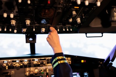 Piloto manejando el panel superior de la cabina